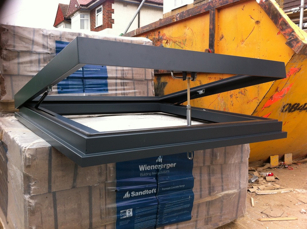 Opening flat roof skylight in anthracite grey installed in Pinner